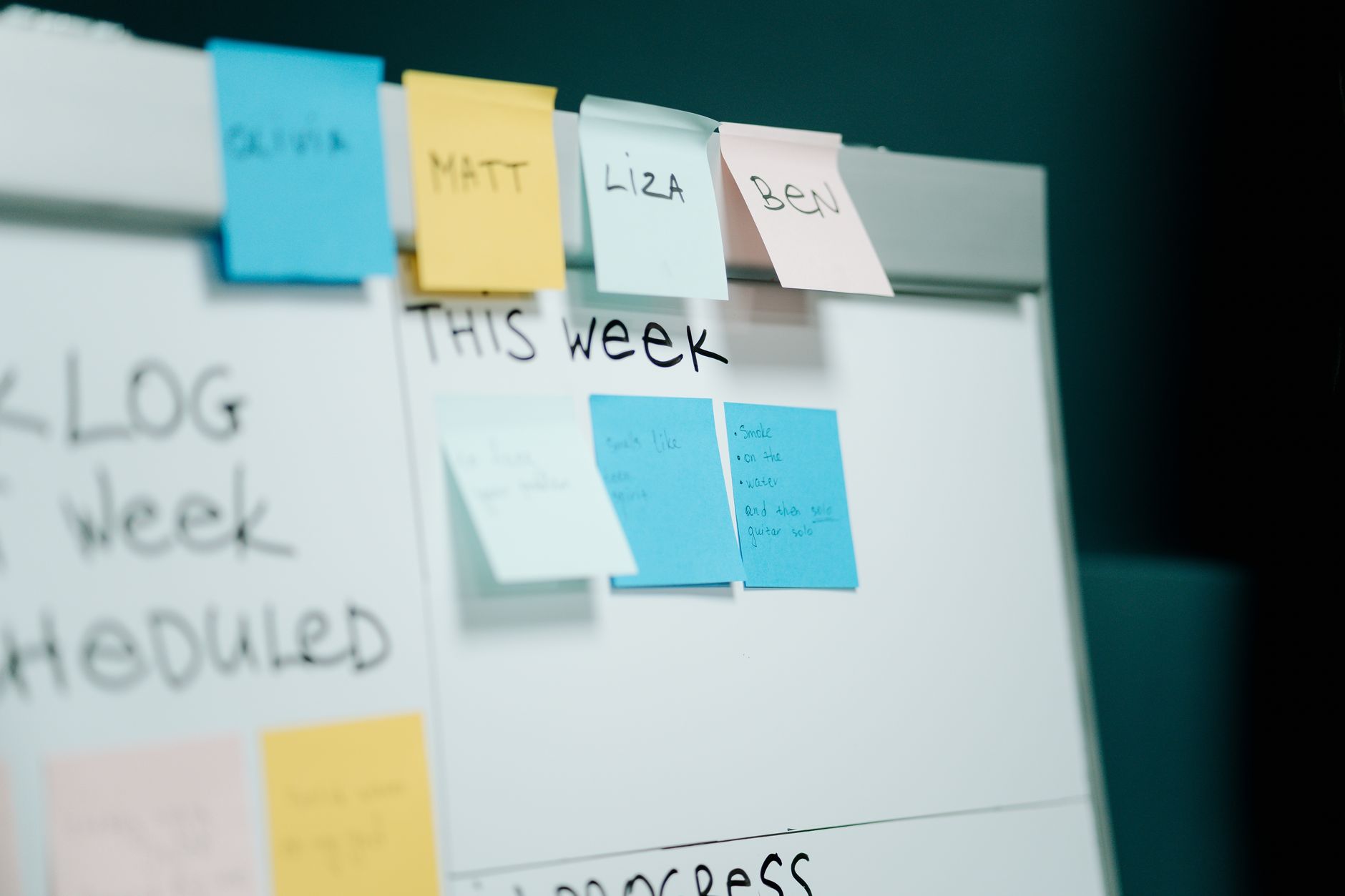 a person mapping a process on a whiteboard with sticky notes