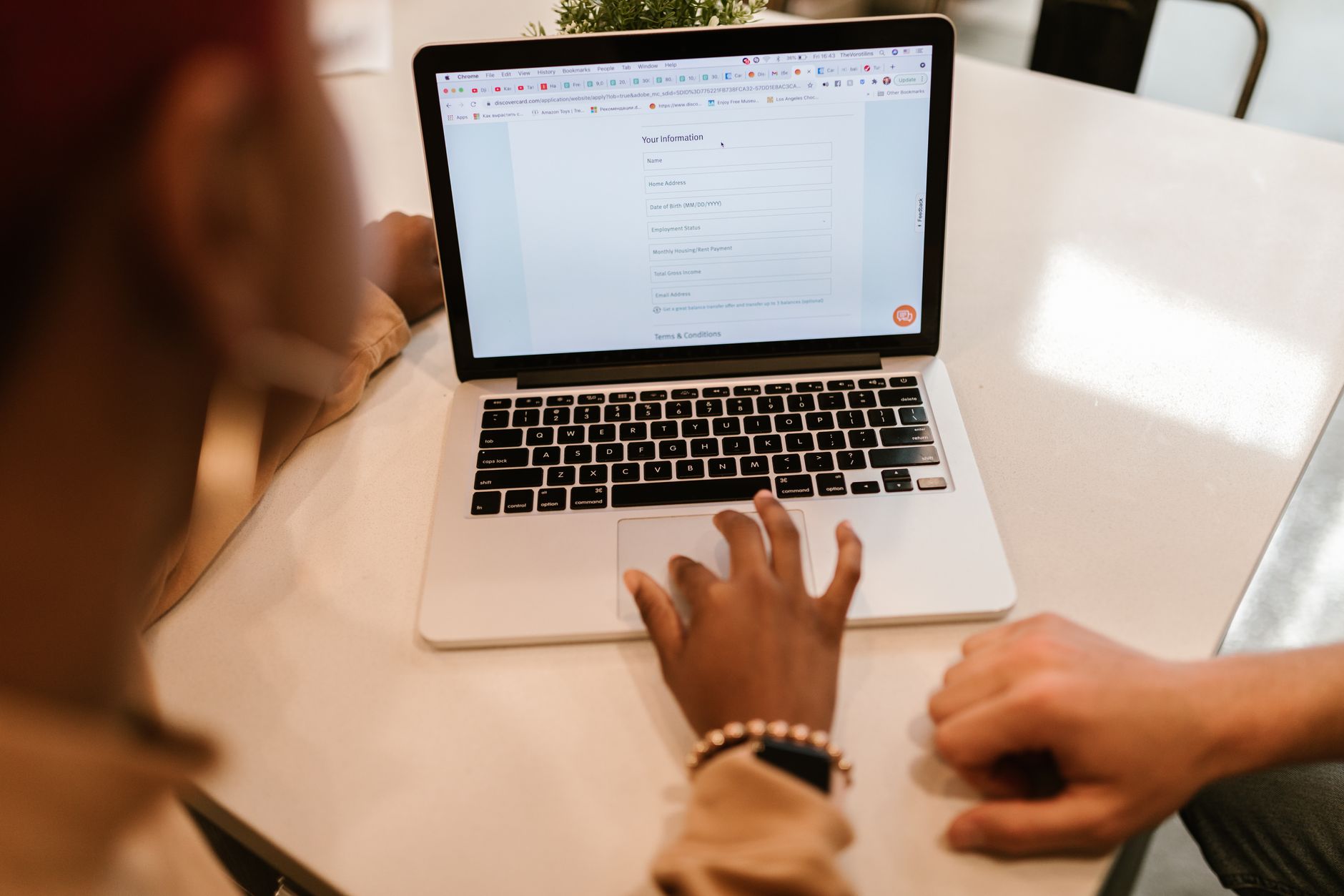 A person typing lead information into an online form on a laptop