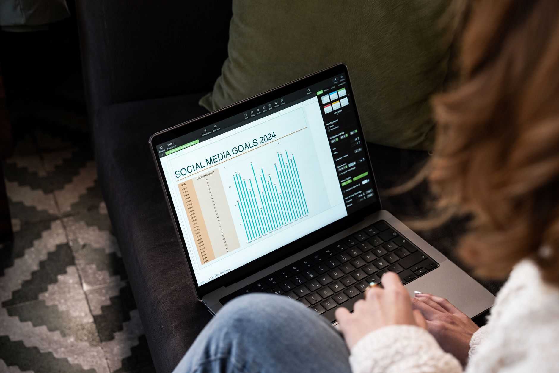 A laptop showing a spreadsheet with social media post ideas and status columns