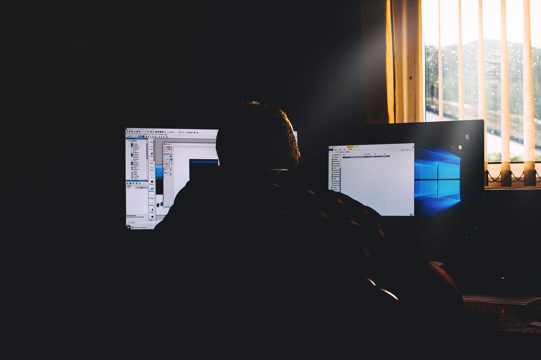 Dual monitors displaying a colorful Make automation scenario flowchart