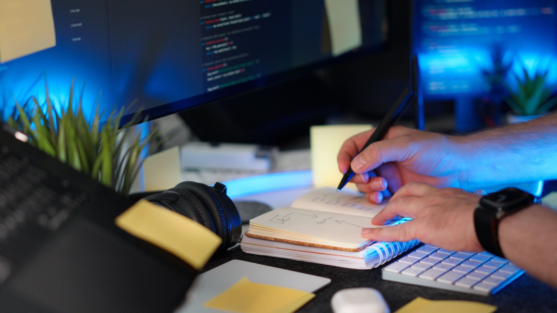 Developer laptop displaying node based automation workflow with code editor open