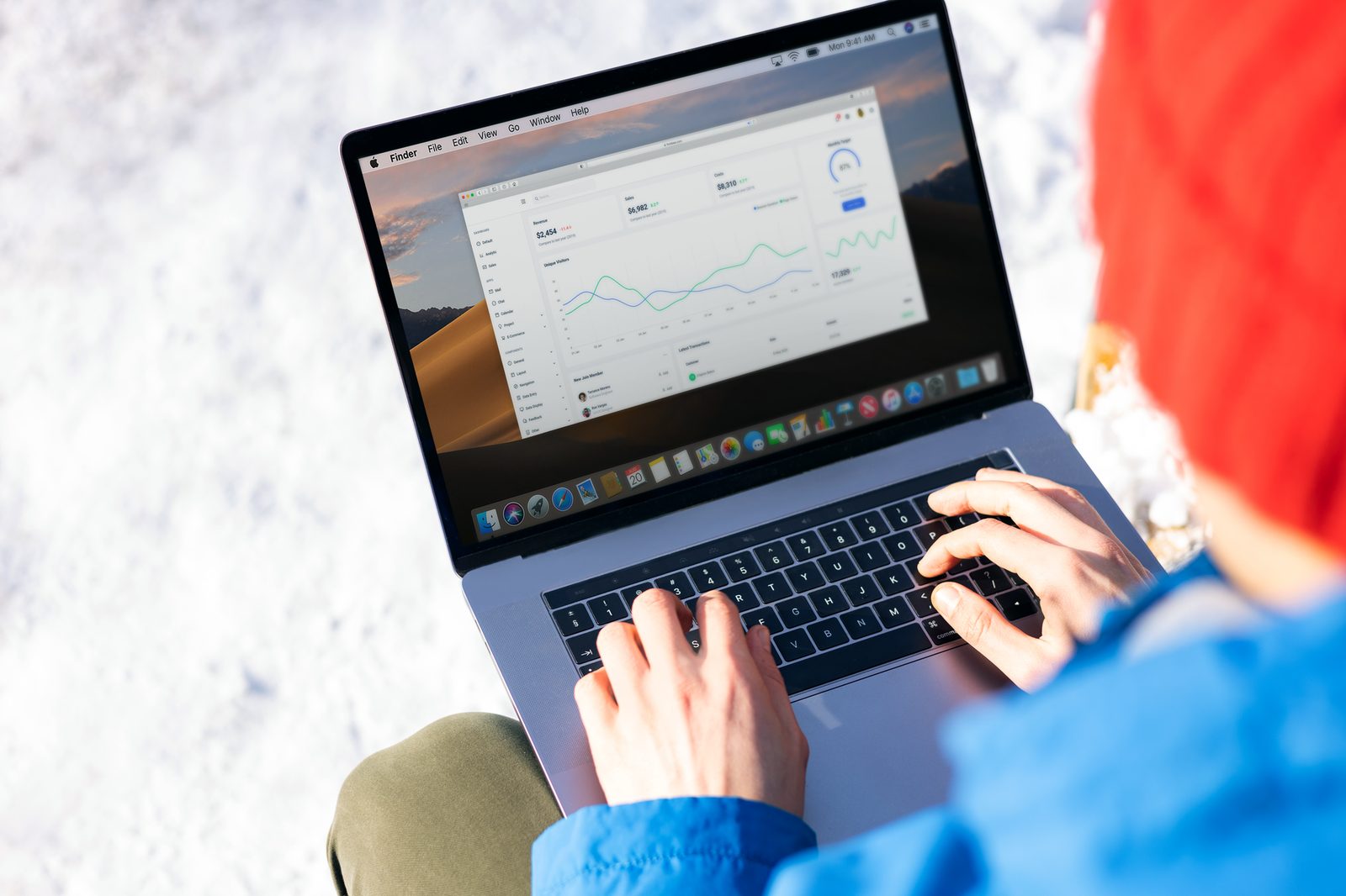 person typing on a laptop with workflow automation dashboard on screen